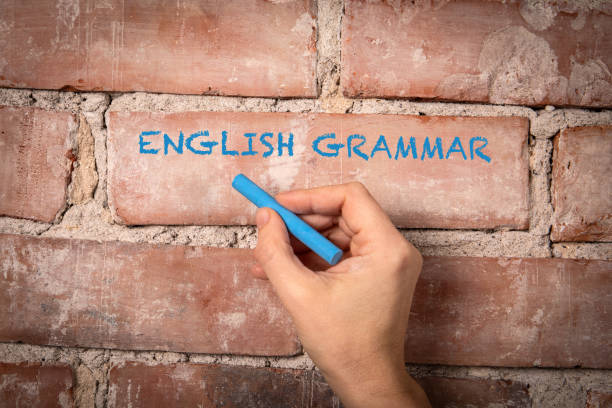 English Grammar. Text written with blue chalk on a red brick background English Grammar. Text written with blue chalk on a red brick background. Universal Grammar? stock pictures, royalty-free photos & images
