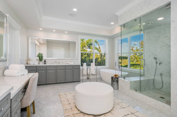 istock Modern bathroom featuring a walk-in shower, bathtub, and a window view 2113096311