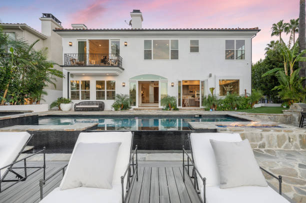istock Chaise lounge chairs poolside at a luxurious residence 2113098382