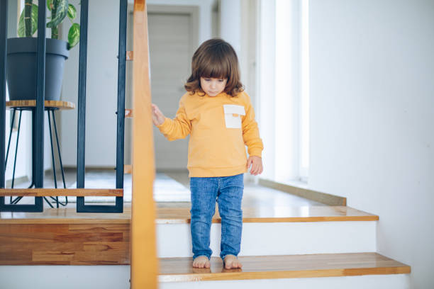 istock Cute toddler boy climbing down the stairs by himself 2113099410