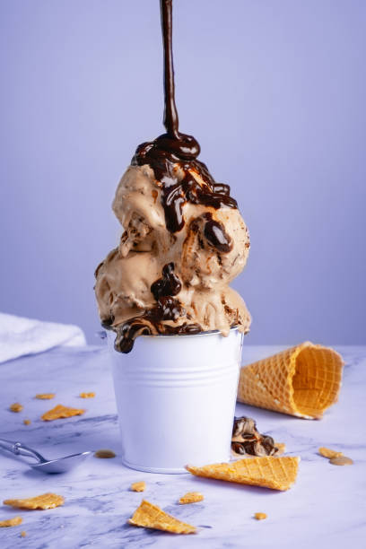 istock Chocolate ice cream with syrup in a white bucket 2113108759