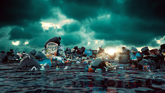 A bleak and striking scene where an expanse of water is heavily littered with garbage. A diverse array of refuse, including numerous black garbage bags, discarded containers, and an assortment of unidentifiable waste, covers the water's surface, creating a dismal 'sea' of trash. The water itself has a dark, almost metallic sheen, possibly indicating oil or chemical pollutants.