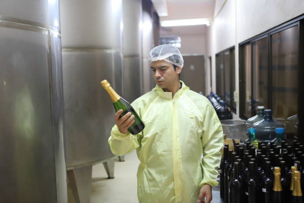 istock Winemaker working in modern large winery factory drink industry  and  testing wine in a wine factory warehouse 2113171157