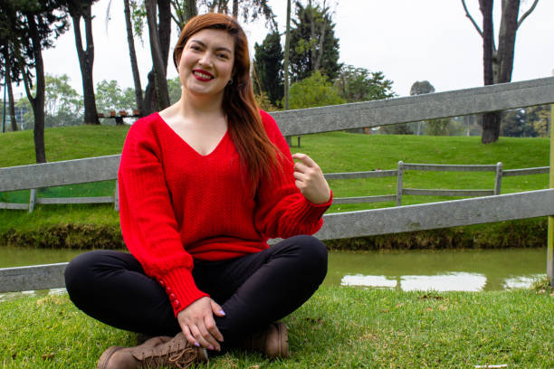 istock Beautiful young woman posing in a public park 2113173822