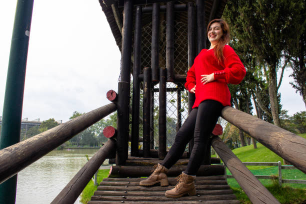 Beautiful young woman posing in a public park
