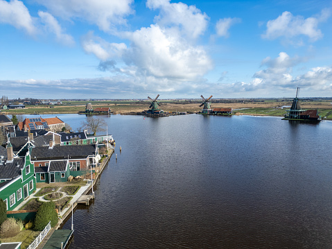 Netherlands - Beautiful old windmills near Amsterdam on the shore of a lake from drone view