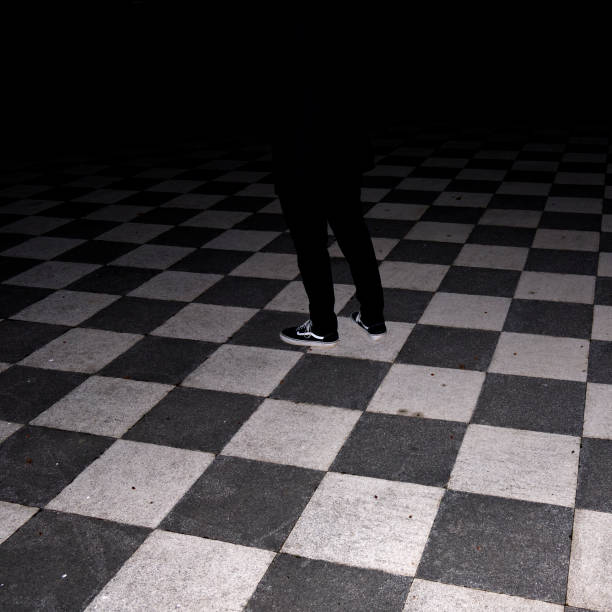mysterious checkered floor with a shadow in the middle of the dark. HQ photo