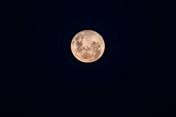 Full Moon, Worm Moon rising in the early evening sky Full Moon Worm Moon rising in the clear night sky as a penumbral lunar eclipse ends at Woy Woy on the Central Coast, NSW, Australia. penumbral lunar eclipse stock pictures, royalty-free photos & images