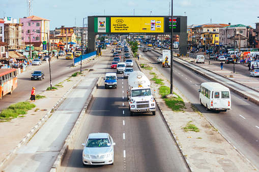 Lagos, Nigeria - Everyday traffic in african megacity under new electronic information banner.