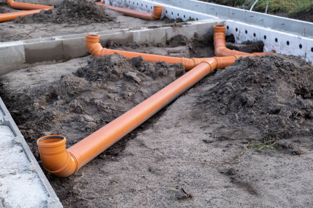istock Ready Made cement foundation and Prepared Drainage System from Plastic pipes made by plumber in the ground during the building of a modular house in Europe. Construction Engineering concept 2113294191