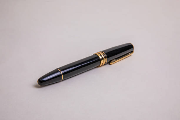 Fountain pen, beautiful fountain pen in detail on rustic wood, selective focus.