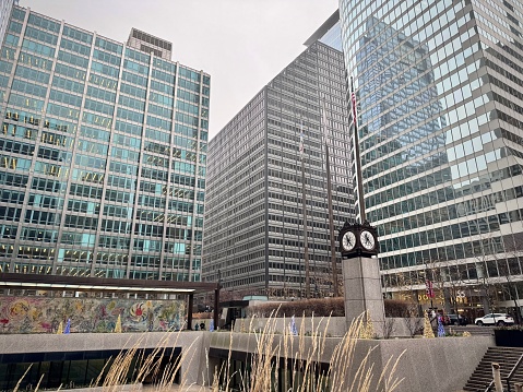 view of a chicago square in the loop district with city buildings and a wall clock on a cold winter day