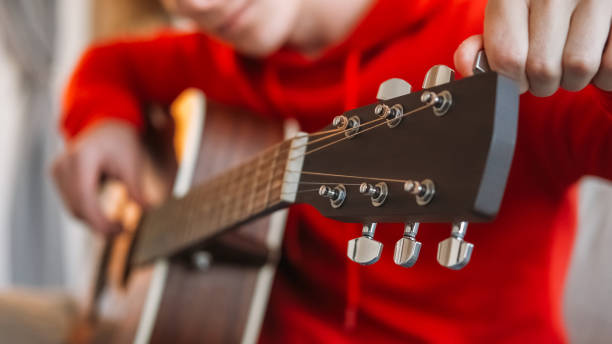 istock Professional musician guitar man hands tuning 2113345159