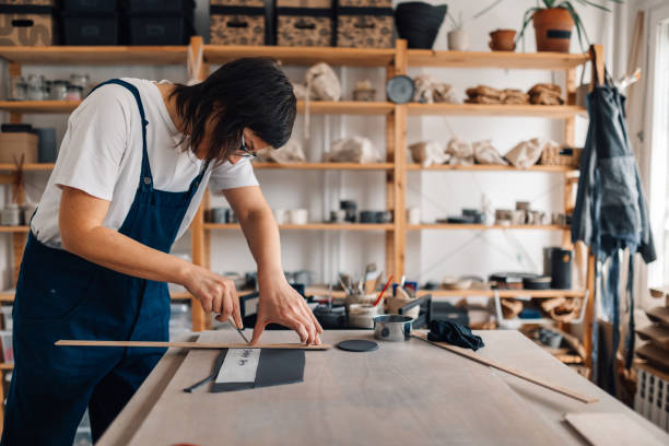istock A precise ceramist is cutting wet clay and modeling it at pottery studio 2113350121