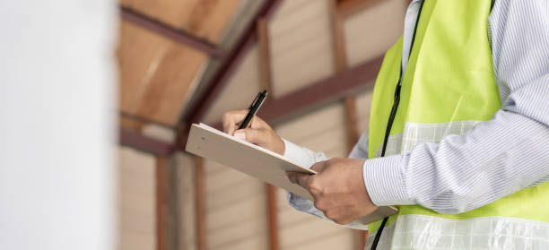 istock inspector or engineer is inspecting construction and quality assurance new house using a checklist. Engineers or architects or contactor work to build the house before handing it over to the homeowner 2113376638