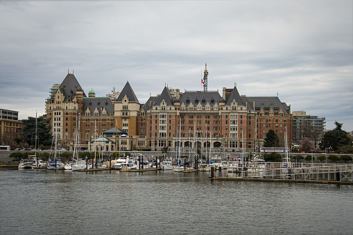 Victoria, B.C., Canada - March 8, 2024: View of the historic Empress Hotel and part of the Inner Harbor with boats in the capital city of B.C.