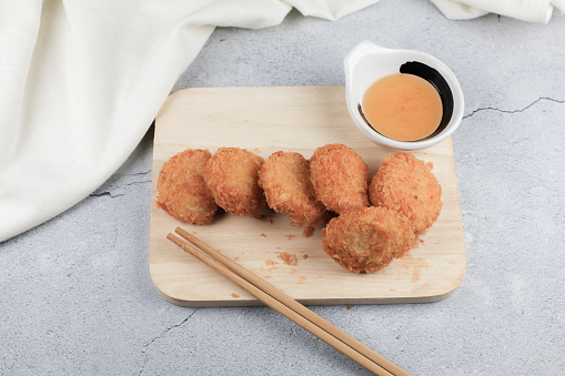 Deep fried shrimp cake with sweet plum sauce. Tod Tod Mun Kung Asian food, made from ground shrimp and other ingredients before rolling in flour, egg and bread crumbs and deep fried.