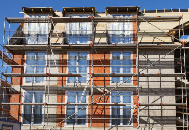 istock The facade of a house under construction with scaffolding 2113449519