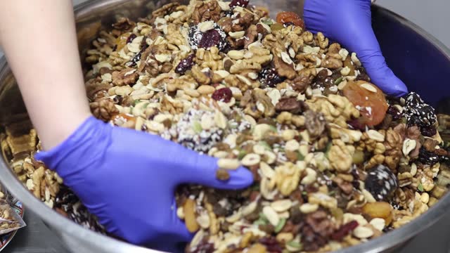 Mixing homemade muesli with nuts and fruits