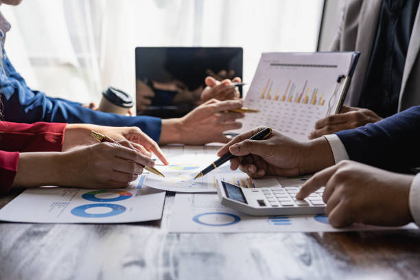 istock A team of analysts works on a financial data analysis dashboard on paper to use as market indicators for planning, strategic brainstorming, financial investments and marketing new business projects. 2113472825