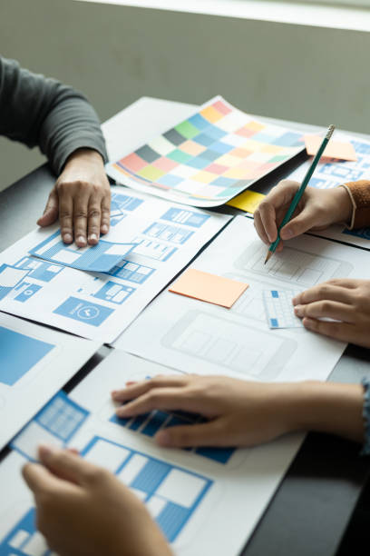 istock A team of UI UX web designers is working together to develop a mobile responsive website that works well on modern phones and supports system updates. Website development concepts UI UX 2113492315