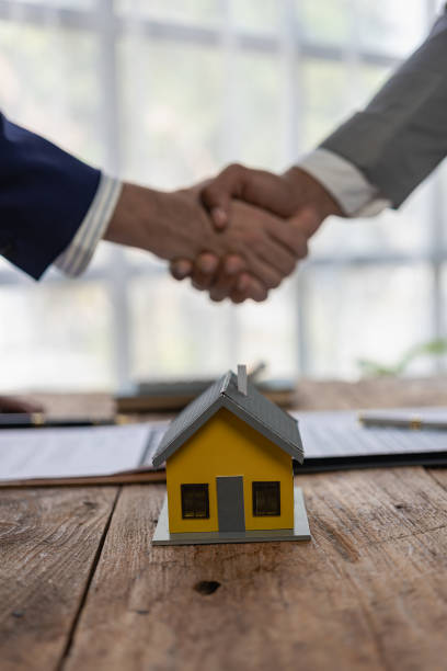 istock Close-up photo of architect and construction engineer holding hands while working for teamwork and cooperation concept after completing agreement in office construction site with house plans on table 2113492469