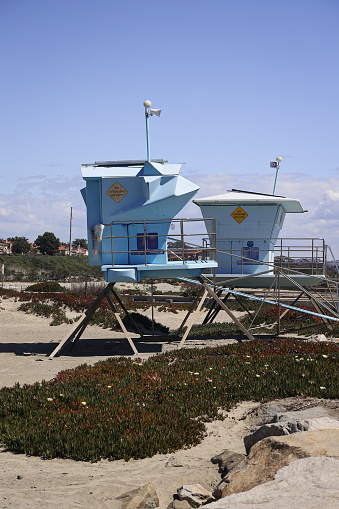 Empty lifeguard towers sitting on the sand in winter in Carlsbad California