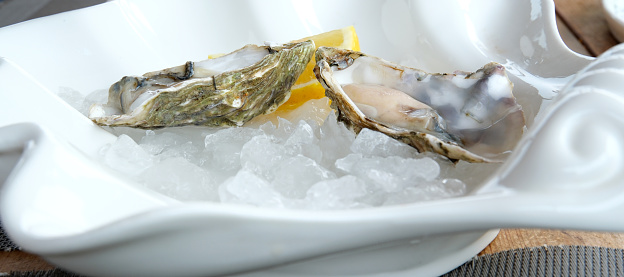 Concept of delicious seafood, oysters, close up. High quality photo