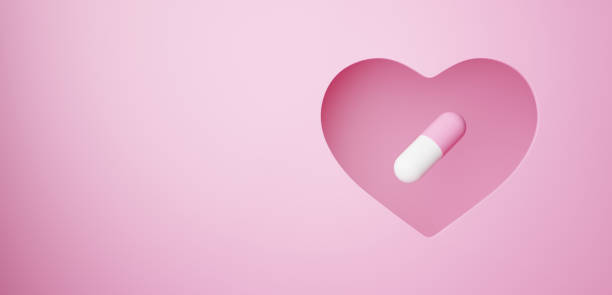 istock 3D Illustration.Capsule on pink background cut out in heart shape. Pill.Copy space.  (horizontal) 2113592115