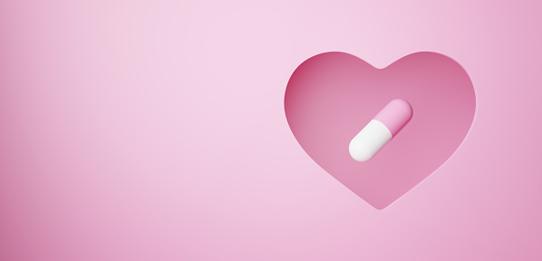 3D Illustration.Capsule on pink background cut out in heart shape. Pill.Copy space.  (horizontal)