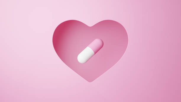 istock 3D Illustration.Capsule on pink background cut out in heart shape. Pill. (horizontal) 2113592117
