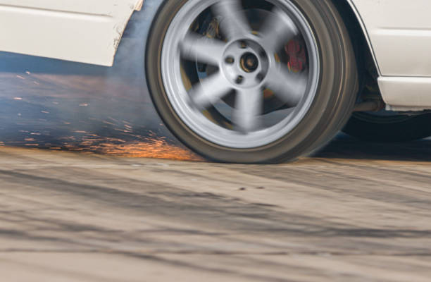 istock EV drift car is burning tires on speed track. 2113690711