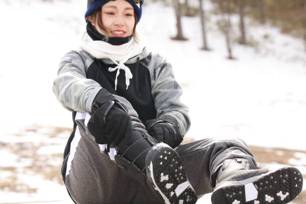 istock woman wearing snowboard boots 2113710465