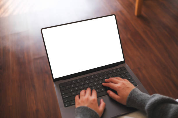 istock Top view mockup image of a woman working and typing on laptop computer with blank screen at home 2113713623
