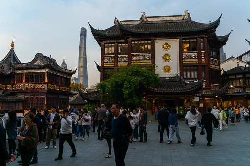 Shanghai, China - March 23rd 2024: Local and tourists enjoying Shanghai's famous traditional architecture of yuyuan garden in evening in downtown Shanghai in China, Asia.