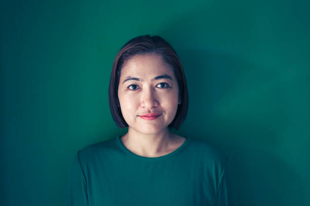 istock Portrait women on the green wall 2113744603