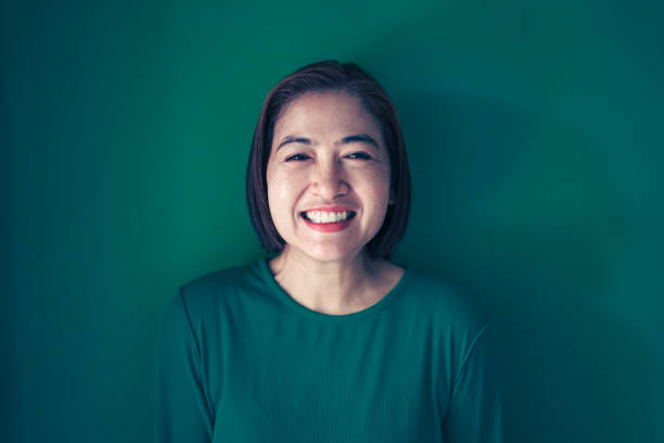 istock Portrait women on the green wall 2113744610