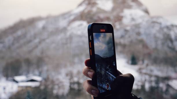 istock Taking pictures in snow mountain 2113751478