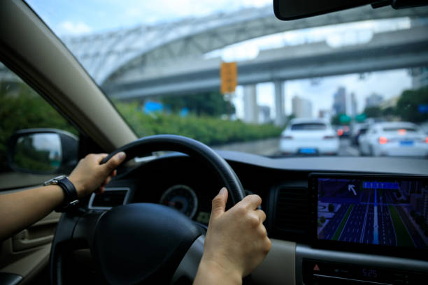 istock People driving car on city road 2113814817