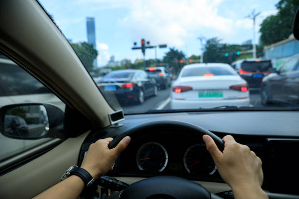 istock People driving car on city road 2113817381