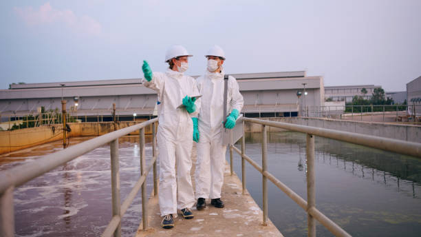istock Two specialists taking water samples at a sewage treatment plant. 2113823072