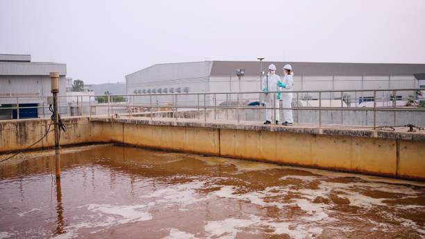 istock Two specialists taking water samples at a sewage treatment plant. 2113823073