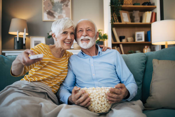 istock Senior heterosexual couple watching movie 2113828780