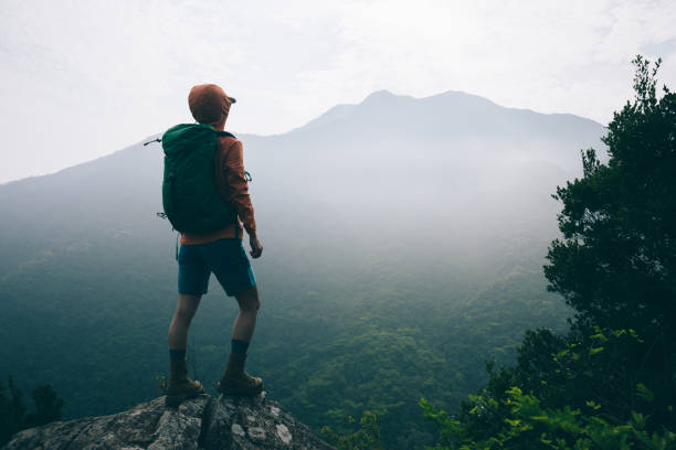 istock Successful hiker enjoy the view on mountain top cliff edge 2113837506