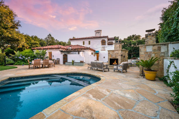 istock a view of a beautiful backyard with a pool and outdoor dining table 2113849230