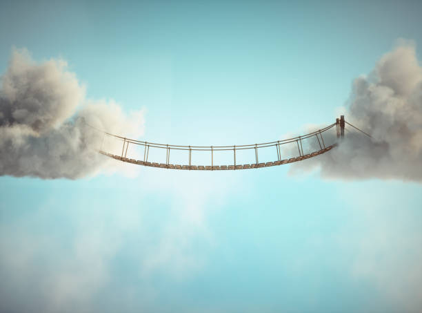 istock Surreal image of a rope bridge connecting two clouds. 2113862140