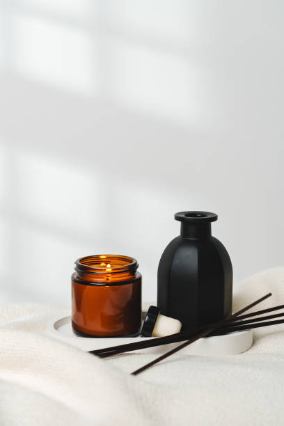 istock Elegant Aroma Diffuser With Reed Sticks And Scented Candle On White Tablecloth 2113895386