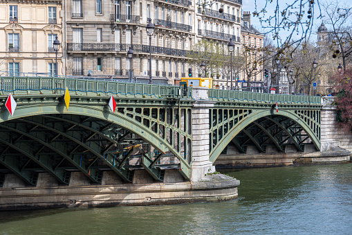 Paris, France - March 26, 2024: View of the Sully bridge and its arch damaged by a boat. The Pont Sully (or Pont de Sully) is a metal arch bridge crossing the Seine in Paris