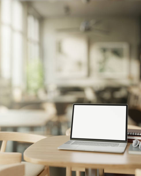 istock A modern, minimalist coffee shop features a white screen laptop computer mockup on a wooden table. 2113941909