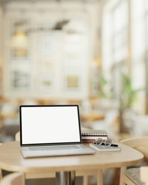 istock A modern, minimalist coffee shop features a white screen laptop computer mockup on a wooden table. 2113942939